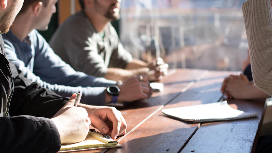 Executives reviewing documents around a meeting table